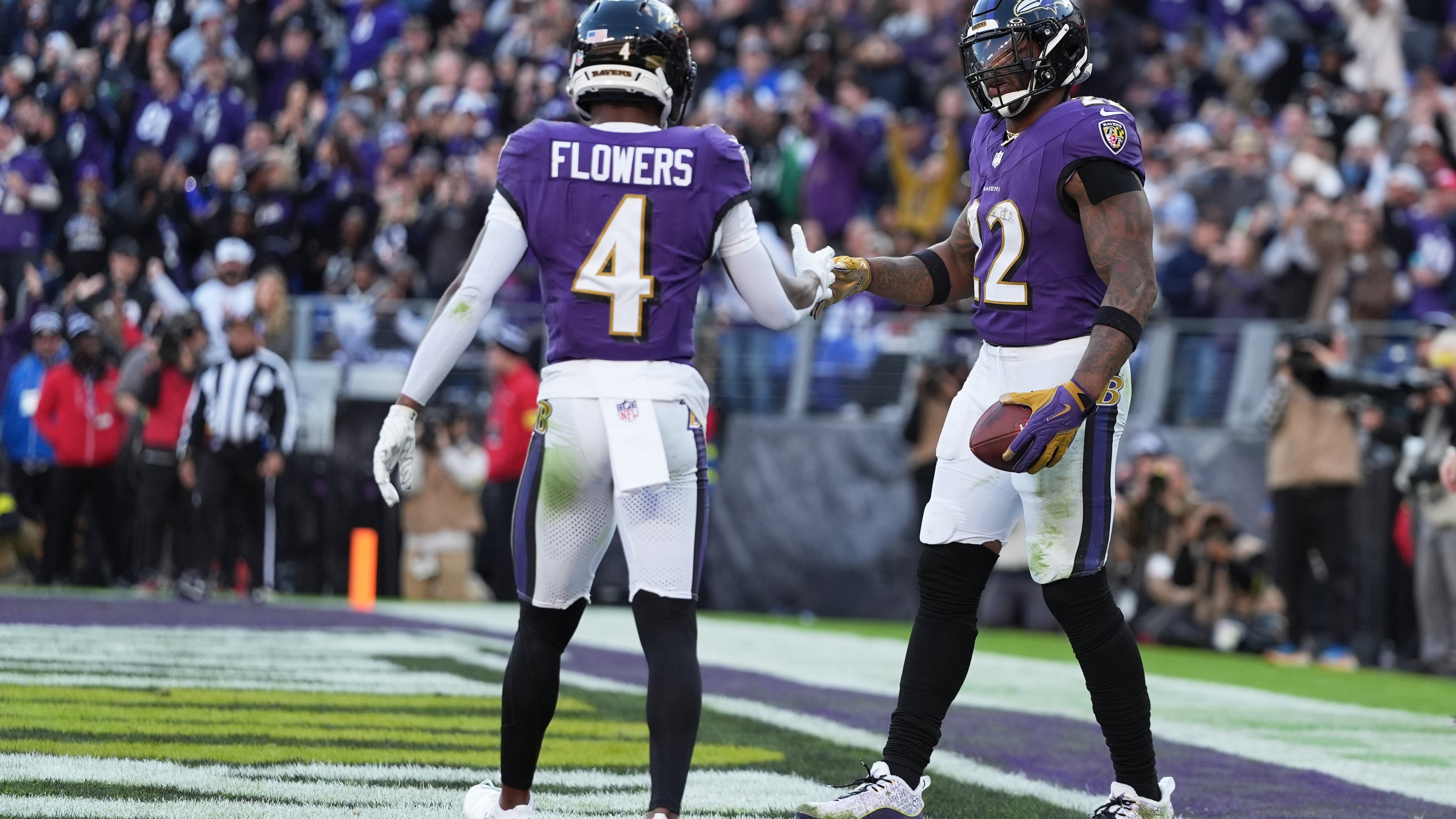 Baltimore Ravens running back Derrick Henry (22) shakes hands with wide receiver Zay Flowers (4) after scoring a touchdown during the second half of an NFL football game against the New York Jets, Sunday, Nov. 23, 2025, in Baltimore. (AP Photo/Stephanie Scarbrough)