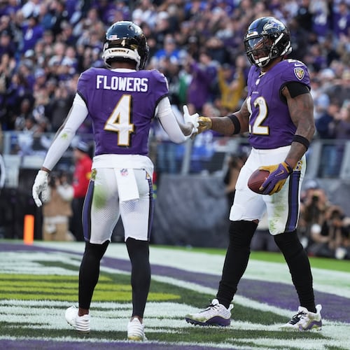 Baltimore Ravens running back Derrick Henry (22) shakes hands with wide receiver Zay Flowers (4) after scoring a touchdown during the second half of an NFL football game against the New York Jets, Sunday, Nov. 23, 2025, in Baltimore. (AP Photo/Stephanie Scarbrough)