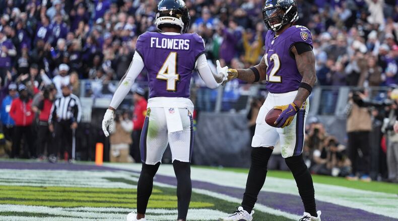 Baltimore Ravens running back Derrick Henry (22) shakes hands with wide receiver Zay Flowers (4) after scoring a touchdown during the second half of an NFL football game against the New York Jets, Sunday, Nov. 23, 2025, in Baltimore. (AP Photo/Stephanie Scarbrough)