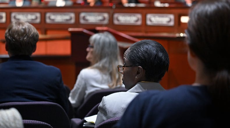 Inspector General Shannon Manigault (center) listens as task force members (background) confer during the first meeting of a task force established to review the inspector general's authority at Atlanta City Hall, Tuesday, September 24, 2024, in Atlanta. The task force established to review the procedures of the Office of the Inspector General and Ethics Office met for the first time Tuesday. (Hyosub Shin / AJC)