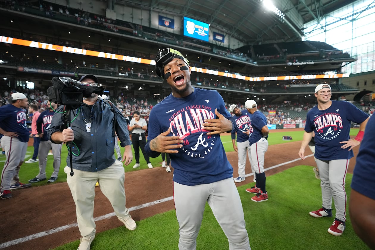 Atlanta Braves' Ronald Acuña Jr. (center) celebrates on the field after a game against the Houston Astros as the Braves clinches the NL East title, Sunday, Sept. 20, 2026, in Houston. (Karen Warren/AP)