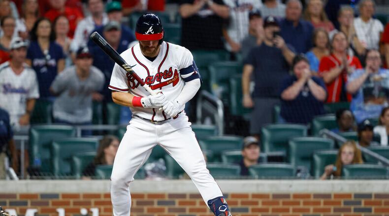 Atlanta Braves' Robbie Grossman earns a bases-loaded walk during the ninth inning of the team's baseball game against the Miami Marlins, driving in the winning run Saturday, Sept. 3, 2022, in Atlanta. (AP Photo/Bob Andres)