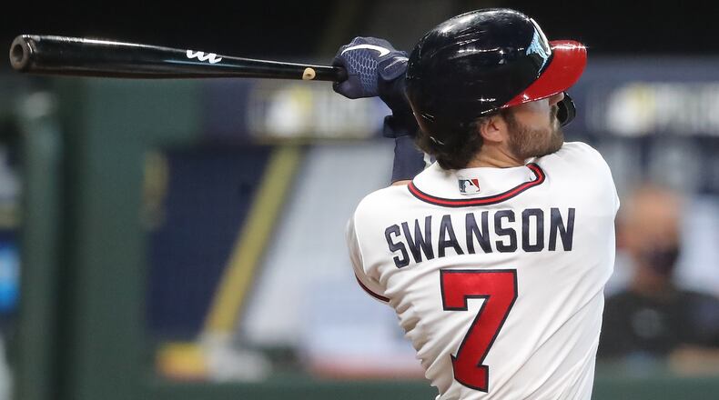 Braves Dansby Swanson hits a two-run homer for a 9-5 lead over the Miami Marlins during the 7th inning in Game 1 of the National League Division Series Tuesday, Oct. 6, 2020, at Minute Maid Park in Houston. (Curtis Compton / Curtis.Compton@ajc.com)