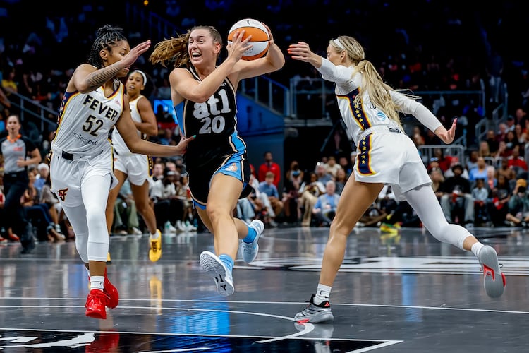 Atlanta Dream guard Isobel Borlase (center) drives against Indiana Fever guards Tyasha Harris (left) and Sophie Cunningham during a WNBA game between the Atlanta Dream and the Indiana Fever, Sunday, Aug. 16, 2026, in Atlanta. The Dream lost 95-91 in overtime. (Erik S. Lesser for the AJC)