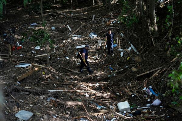 Search and rescue teams from Kerrville Fire Department search through debris after flooding near the banks of the Guadalupe River in Kerrville, Texas on Tuesday, July 8, 2025. (AP Photo/Ashley Landis)
