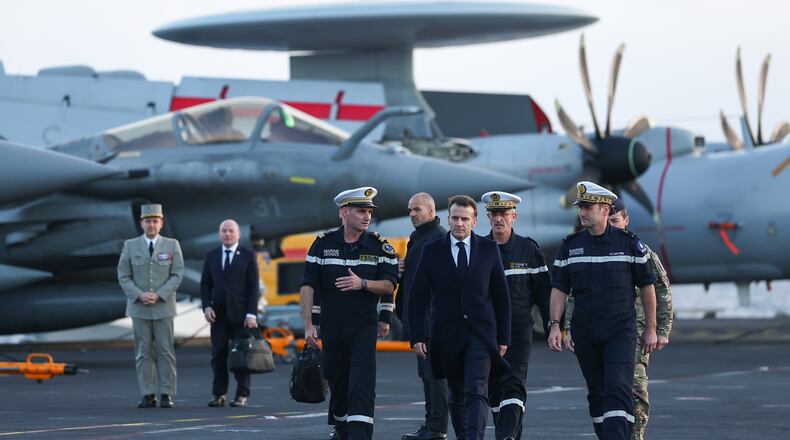 FILE - French President Emmanuel Macron, center right, visits the French aircraft carrier Charles de Gaulle, during his visit to Cyprus, March 9, 2026. (Gonzalo Fuentes/Pool Photo via AP, File)