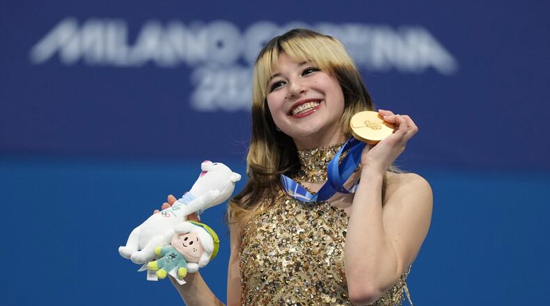 Gold medalist Alysa Liu of the United States displays her medal after competing in the women's free skate program in figure skating at the 2026 Winter Olympics, in Milan, Italy, Thursday, Feb. 19, 2026. (AP Photo/Stephanie Scarbrough)