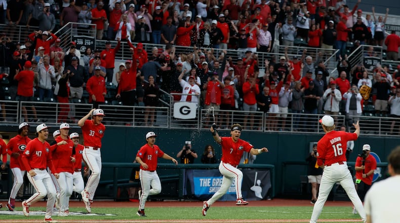 Georgia players rushed to celebrate with pitcher Zach Brown (right) after the team defeated Liberty 6-1 in an NCAA Regional final at Foley Field on Sunday, May 31, 2026, in Athens. (Miguel Martinez/AJC)