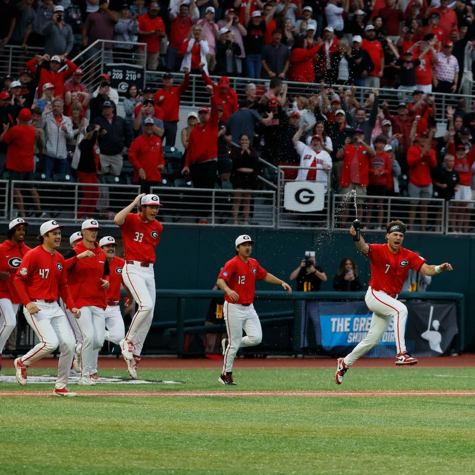 Georgia players rushed to celebrate with pitcher Zach Brown (right) after the team defeated Liberty 6-1 in an NCAA Regional final at Foley Field on Sunday, May 31, 2026, in Athens. (Miguel Martinez/AJC)