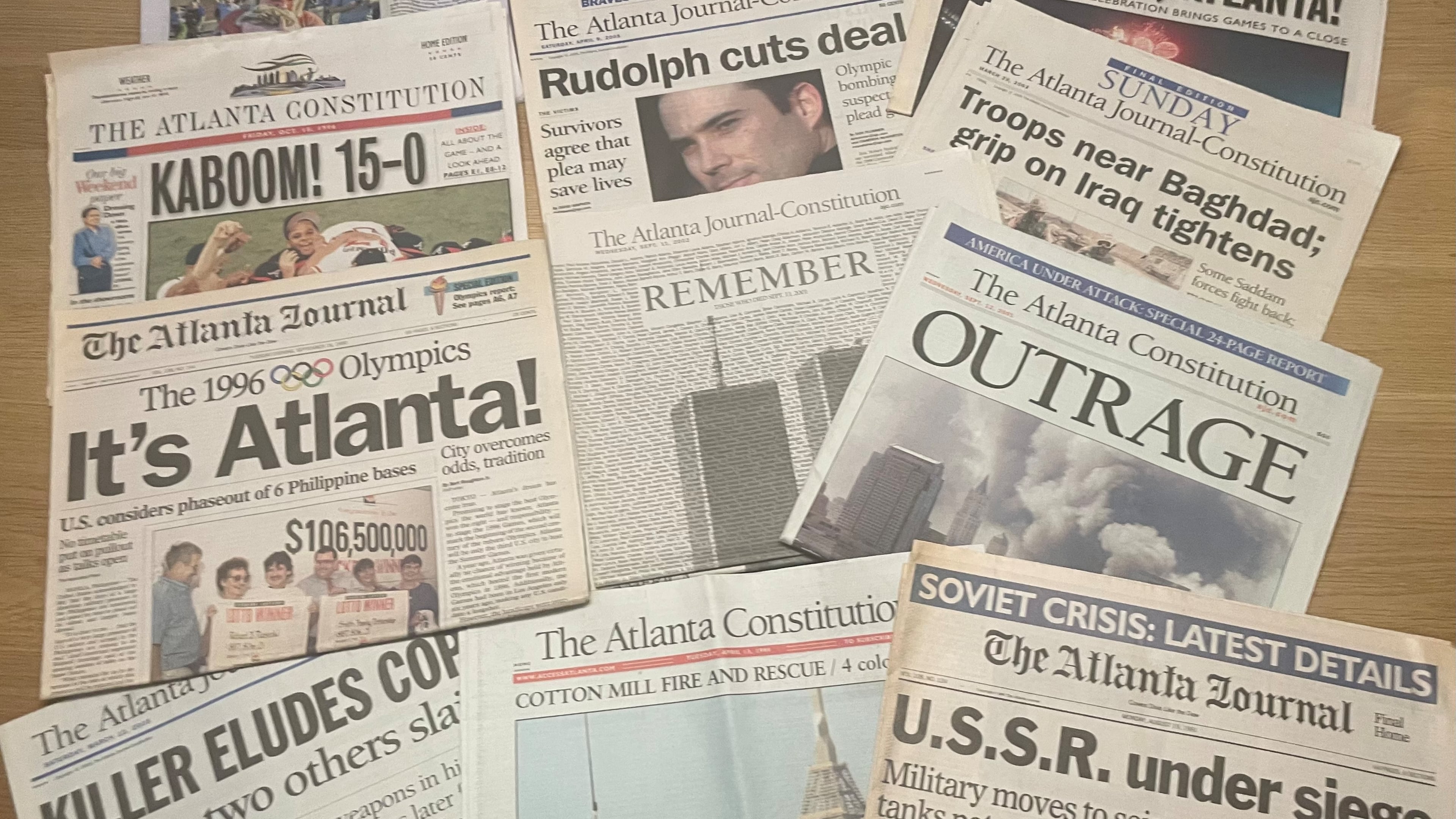 Copies of notable Atlanta Journal-Constitution headlines saved in Bill Torpy's basement. (Bill Torpy/AJC)