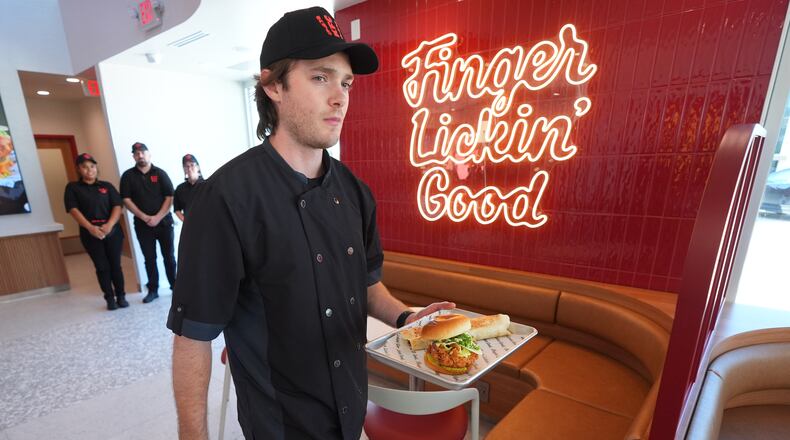 Jacob Mitchell carries a tray of food at new KFC restaurant pre-opening presentation in McKinney, Texas, Tuesday, Sept. 22, 2026. (AP Photo/LM Otero)