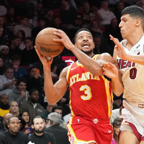 Atlanta Hawks guard CJ McCollum (3) drives to the basket as Miami Heat forward Simone Fontecchio (0) defends during the first half of an NBA basketball game Tuesday, Feb. 3, 2026, in Miami. (AP Photo/Marta Lavandier)