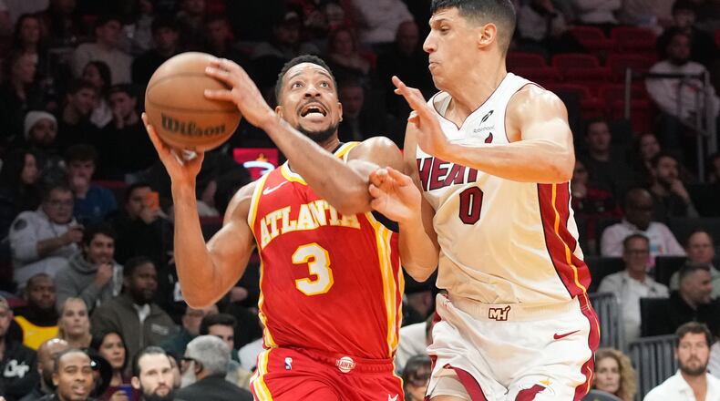Atlanta Hawks guard CJ McCollum (3) drives to the basket as Miami Heat forward Simone Fontecchio (0) defends during the first half of an NBA basketball game Tuesday, Feb. 3, 2026, in Miami. (AP Photo/Marta Lavandier)