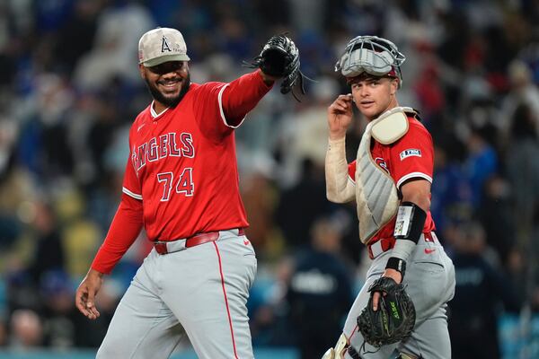 Los Angeles Angels relief pitcher Kenley Jansen, left gestures toward the Los Angeles Dodgers dugout as catcher Logan O'Hoppe looks on after the Angels defeated the a dodgers 11-9 in a baseball game Saturday, May 17, 2025, in Los Angeles. (AP Photo/Mark J. Terrill)