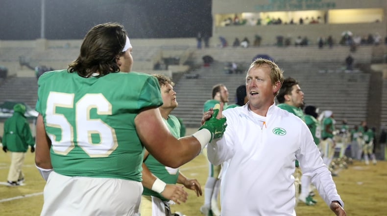 November 23, 2018 - Buford, Ga: Former Buford coach John Ford, now at Effingham County, greets lineman Reece McIntyre (56) before their game against Bainbridge at Buford High School Friday, November 23, 2018, in Buford, Ga. This is the quarter finals of the Class 5A state playoffs. (JASON GETZ/SPECIAL TO THE AJC)