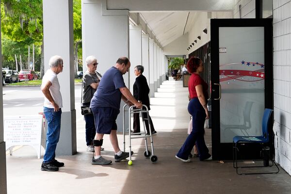 Early voters line up outside the Supervisor of Elections office Tuesday, March 25, 2025, in DeLand, Fla. (AP Photo/John Raoux)
