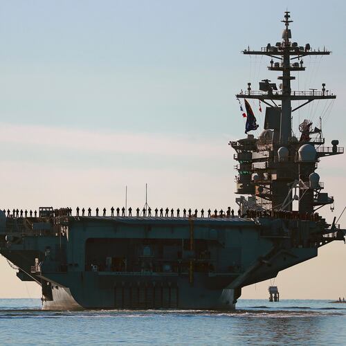 FILE - Sailors and Marines line the deck of aircraft carrier USS Abraham Lincoln (CVN-72) as it deploys from San Diego, Jan. 3, 2021. (K.C. Alfred/The San Diego Union-Tribune via AP, File)