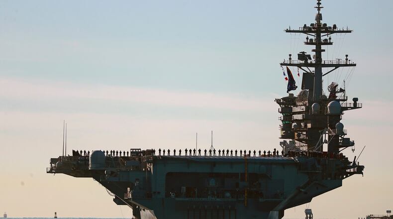 FILE - Sailors and Marines line the deck of aircraft carrier USS Abraham Lincoln (CVN-72) as it deploys from San Diego, Jan. 3, 2021. (K.C. Alfred/The San Diego Union-Tribune via AP, File)