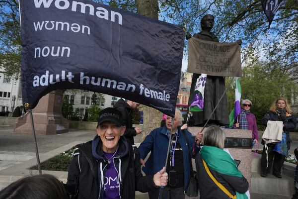 Women's rights activists hold placards outside the Supreme Court to challenge gender recognition laws, in London, Wednesday, April 16, 2025. (AP Photo/Kin Cheung)