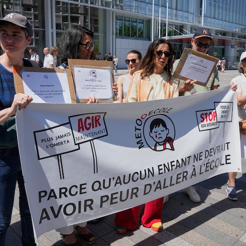 Members and supporters of the #METooEcole (#METooSchool) movement stage a protest to draw attention to a child abuse scandal in France in front of the courthouse in Paris on Tuesday May 26, 2026. The banner reads, in French, "Because no child should ever be afraid to go to school." (AP Photo/Michel Euler)