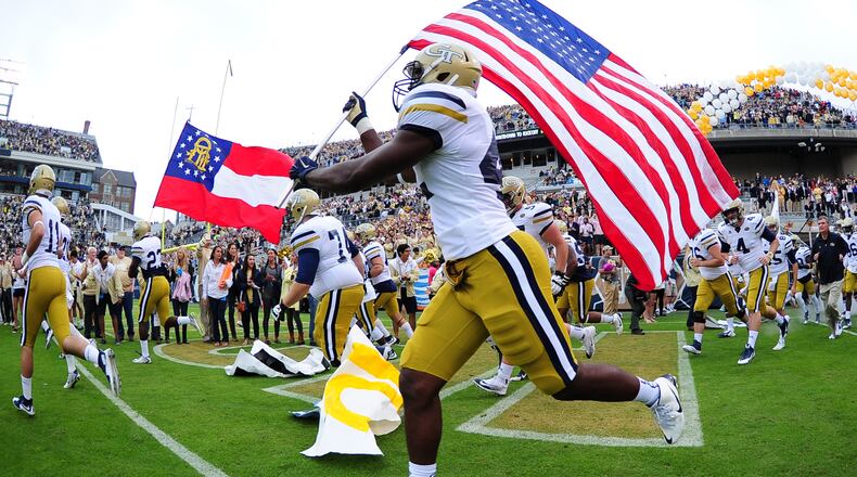 ATLANTA, GA - OCTOBER 3: KeShun Freeman #42 of the Georgia Tech Yellow Jackets carries the American flag as he takes the field against the North Carolina Tar Heels on October 3, 2015 in Atlanta, Georgia. Photo by Scott Cunningham/Getty Images)