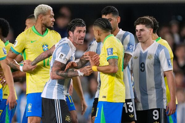 Argentina's Rodrigo De Paul, left, and Brazil's Raphinha argue during a World Cup 2026 qualifying soccer match at Monumental Stadium in Buenos Aires, Argentina, Tuesday, March 25, 2025. (AP Photo/Gustavo Garello)