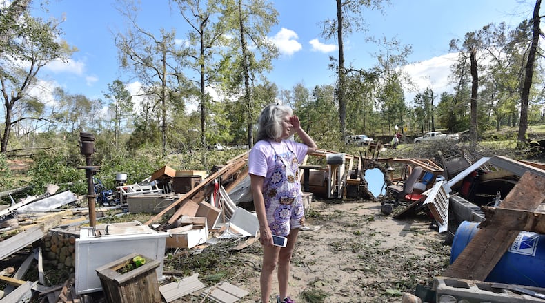 Sharon Granade stands on her destroyed two-car garage after Tropical Storm Michael  passed on Flint River Estates Road in Roberta, Ga. on Thursday, October 11, 2018. Tropical Storm Michael swept out of Georgia before sunrise, leaving a trail of destruction in its wake.