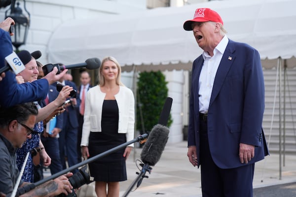 President Donald Trump speaks to the media before walking across the South Lawn of the White House to board Marine One en route to Joint Base Andrews, Md., and on to Florida, Tuesday, July 1, 2025, in Washington. (AP Photo/Mark Schiefelbein)