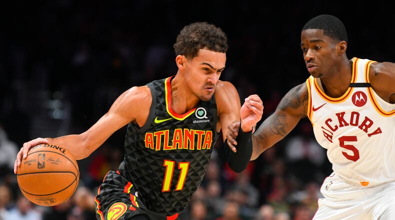 Atlanta Hawks guard Trae Young (11) drives against Indiana Pacers guard Edmond Sumner during the first half of an NBA basketball game Saturday, Jan. 4, 2020, in Atlanta. (AP Photo/John Amis)
