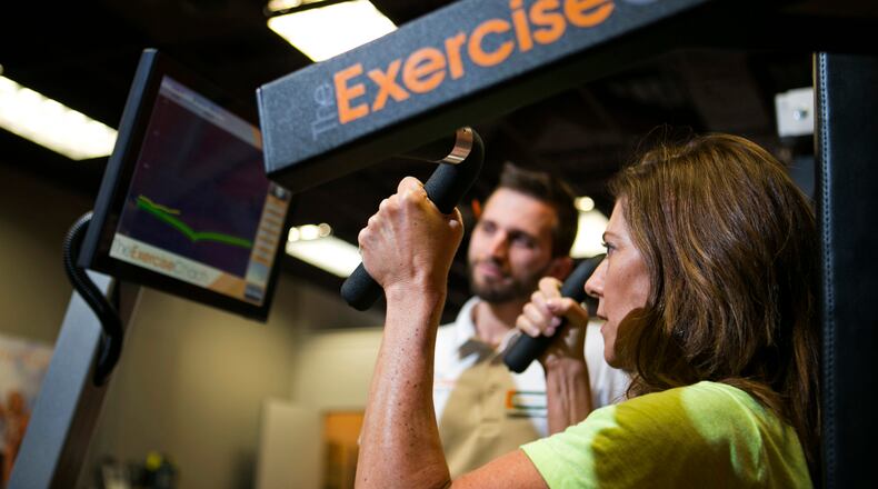 April 1, 2016 - Roswell, Ga: Client Susan Gleeson, of Alpharetta, works out on a pulldown exercise machine at Exercise Coach Friday, April 1, 2016, in Roswell, Ga. This is an article about Exercise Coach's unique equipment, coaches, and training regiment. PHOTO / JASON GETZ