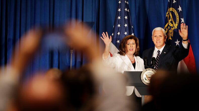 Vice President Mike Pence, right, waves to the crowd after speaking at a campaign fundraiser for Republican candidate for 6th congressional district Karen Handel, left, at the Cobb Energy Performing Arts Centre in Atlanta, Friday, June 9, 2017. (AP Photo/David Goldman)