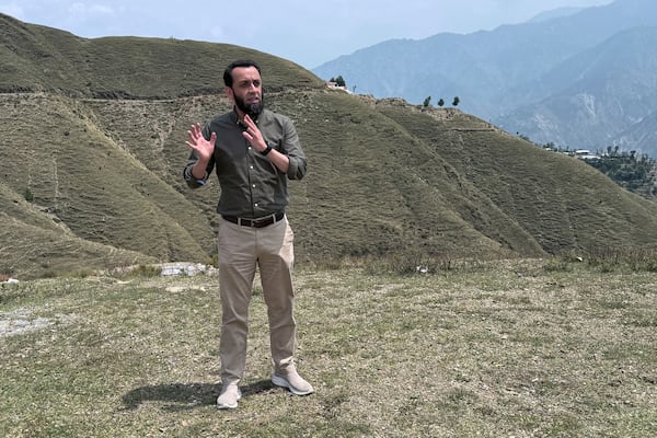 Pakistan's Information Minister Attaullah Tarar, center, briefs journalists during a government's organized trip for media to Bella Noor Shah, a mountainous village near Muzaffarabad, the capital of Pakistan administered Kashmir, Monday, May 5, 2025. (AP Photo/Muhammad Yousuf, Pool)