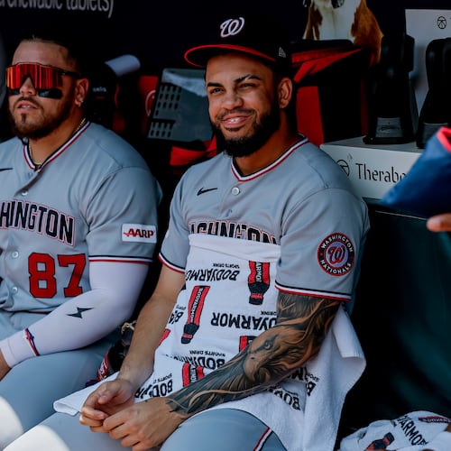Washington Nationals' Luis García Jr., right, sits in the dugout with Andrés Chaparro (87) after he was scratched from the starting lineup before a baseball game against the Atlanta Braves, Sunday, Aug. 2, 2026, in Atlanta. (AP Photo/Erik S. Lesser)