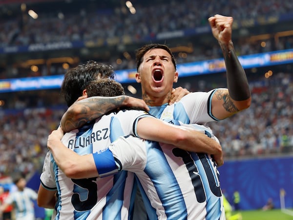 Argentina's Enzo Fernandez cheers as he and teammates celebrate Lionel Messi's tying goal during second half of Argentina vs. Egypt. Fernandez would go on to score the winning goal a few minutes later at the FIFA World Cup match at Atlanta Stadium (Mercedes-Benz Stadium) on Tuesday, July 7, 2026. (Miguel Martinez/AJC)