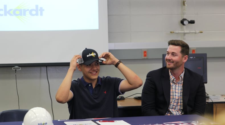 Alexander Avellaneda (left) is the first student in Berkmar High School’s construction pathway to career program to sign on for a full-time job with a program sponsor. Ashton Watt of Eckardt Electric (left) congratulates the student on his hard work and dedication. CONTRIBUTED