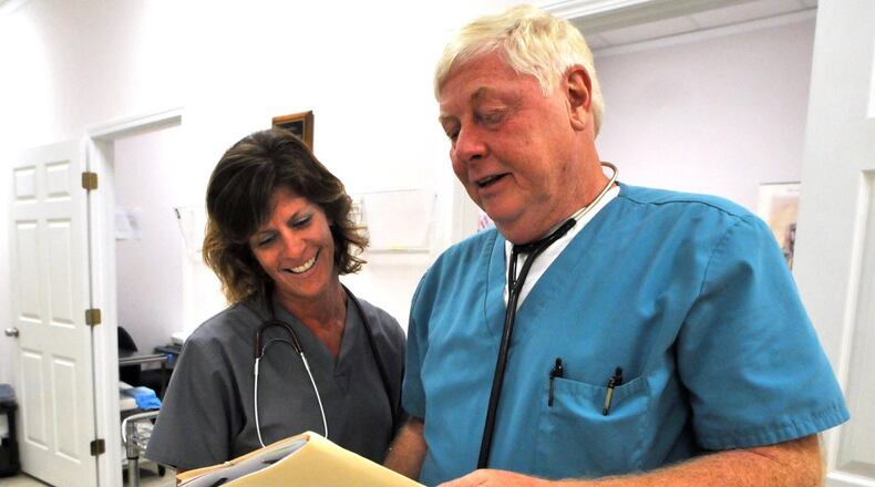 Dr. Jack Heneisen looks over a chart with Tonya Jackson inside his Rincon Office. After serving time in federal prison related to the illegal prescription of a painkiller, Heneisen said he couldn’t afford malpractice insurance. MANDATORY CREDIT: Richard Burkhart/Savannah Morning News