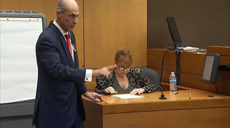 Defense attorney Bruce Harvey has witness Dani Jo Carter look at a document during the murder trial of Tex McIver on Tuesday. “Wasn’t that just the dumbest thing?” he said of McIver’s request for Carter to lie about her involvement in the shooting. (Channel 2 Action News)