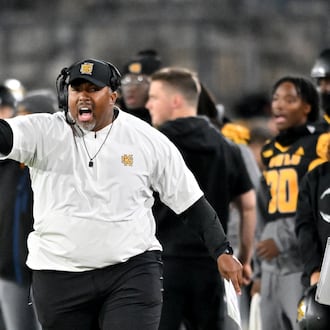 Kennesaw State head coach Jerry Mack shouts instructions during the first half in an NCAA college football game at Fifth Third Stadium, Tuesday, October 28, 2025, in Kennesaw. (Hyosub Shin/AJC)