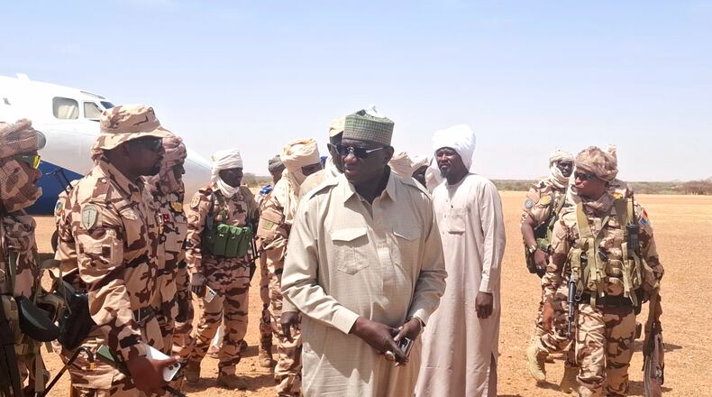 In this photo release by the Chadian Press Agency, Limane Mahamat, deputy prime minister, center, arrives at Igote village following a clash between two families over a water point, in the Wadi Fira, Chad, Sunday, April 26, 2026. (Chadian Press Agency via AP)