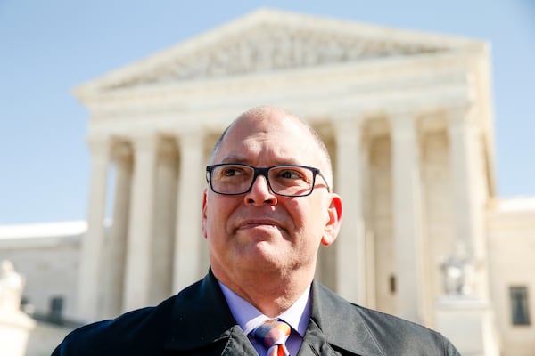 FILE - James Obergefell of the Human Rights Campaign speaks to a journalist as the campaign delivers copies of the "People's Brief," calling for full nationwide marriage equality, in Washington, March 6, 2015. (AP Photo/Andrew Harnik, File)