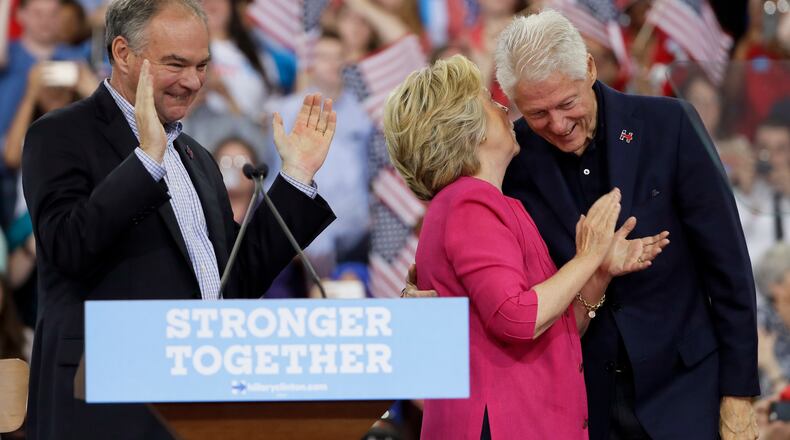 Democratic presidential candidate Hillary Clinton talks with her husband, former President Bill Clinton after a campaign rally at Temple University with Democratic vice presidential candidate, Sen. Tim Kaine, D-Va., Friday, July 29, 2016, in Philadelphia. (AP Photo/Matt Slocum)