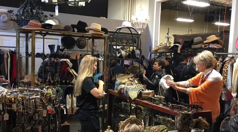 About 100 shoppers arrived before the doors opened on the first day of the Diane McIver estate sale which featured hundreds of items of clothing, shoes and accessories. The five-day sale runs through Sunday, when any remaining items will be priced at 50 percent off.