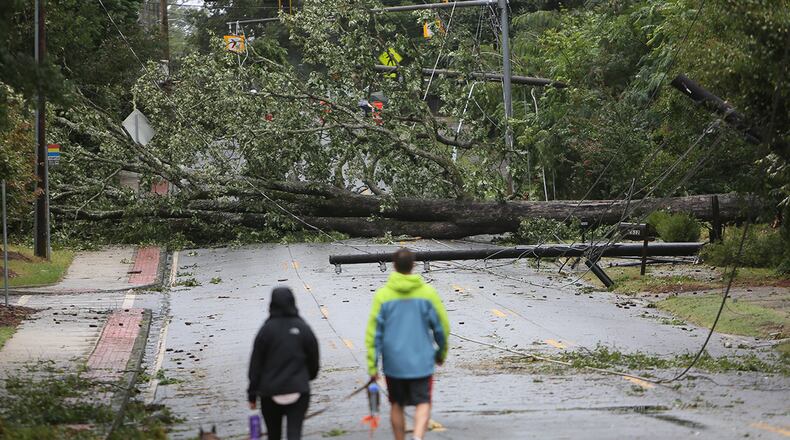Trees downed by Tropical Storm Irma like this one on Memorial Drive in DeKalb County on Tuesday caused countywide power outages that last four days later.