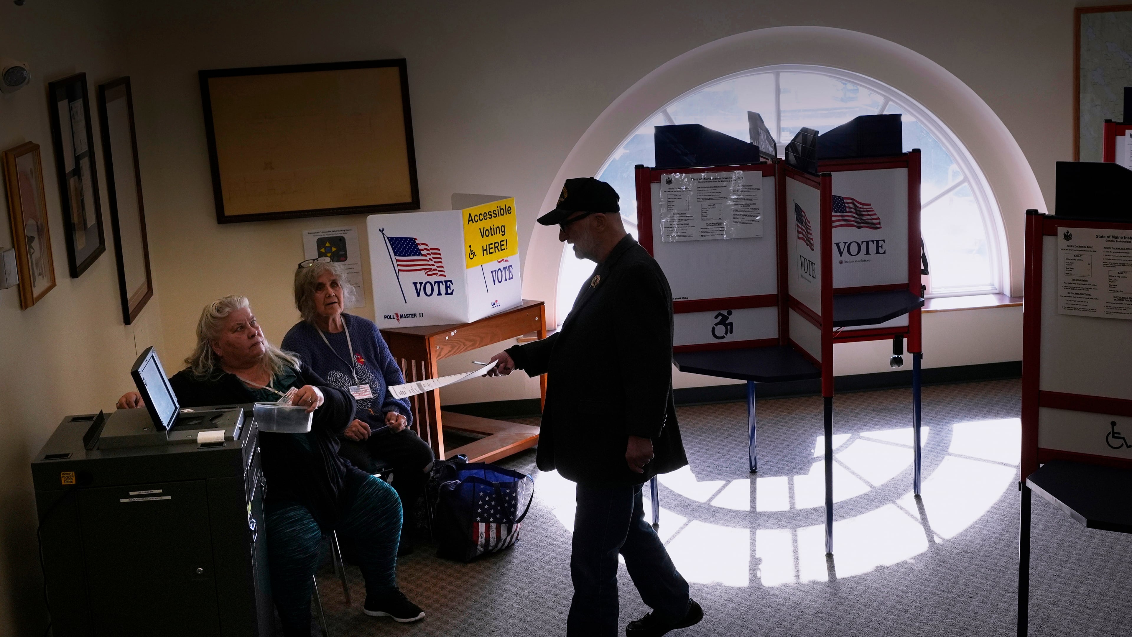 Terry O'Neill casts his ballot while voting at City Hall, Tuesday, Nov. 4, 2025, in Ellsworth, Maine. (AP Photo/Robert F. Bukaty)