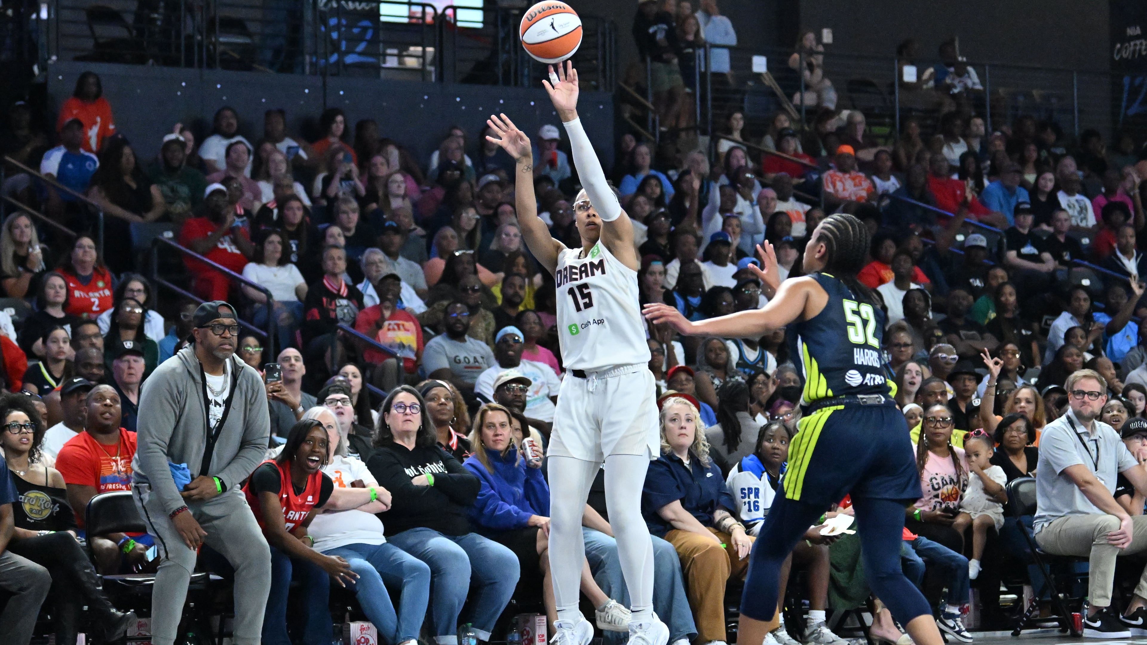 Atlanta Dream guard Allisha Gray (15) shoots a 3-point basket over Dallas Wings guard Tyasha Harris (52) during the second half in a WNBA basketball game at Gateway Center Arena, Saturday, May 24, 2025, in Atlanta. Atlanta Dream won 83-75 over Dallas Wings. (Hyosub Shin / AJC)
