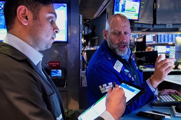 Trader Niall Pawa, left, and Specialist Meric Greenbaum work on the floor of the New York Stock Exchange, Wednesday, April 23, 2025. (AP Photo/Richard Drew)