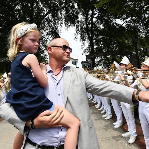 Georgia Tech coach Brent Key and his daughter, Harper, arrive with players and coaches before the home opener Sept. 6, 2025, against Gardner-Webb at Bobby Dodd Stadium in Atlanta. (Hyosub Shin/AJC)
