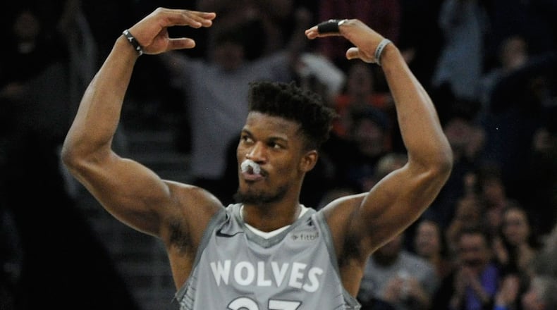 Jimmy Butler #23 and Karl-Anthony Towns #32 of the Minnesota Timberwolves celebrate in the final minute of overtime of the game against the Denver Nuggets on April 11, 2018 at the Target Center in Minneapolis, Minnesota. The Timberwolves defeated the Nuggets 112-106. NOTE TO USER: User expressly acknowledges and agrees that, by downloading and or using this Photograph, user is consenting to the terms and conditions of the Getty Images License Agreement.