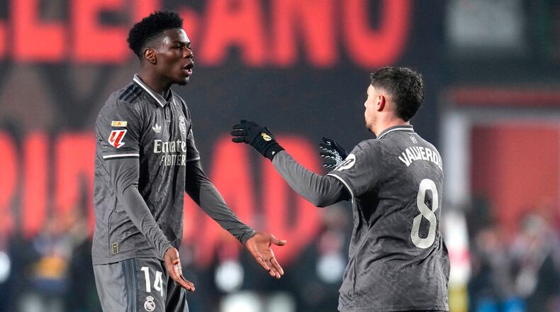 FILE - Real Madrid's Federico Valverde, right, celebrates with Aurelien Tchouameni after scoring his side's opening goal during the Spanish La Liga soccer match between Rayo Vallecano and Real Madrid at the Vallecas stadium in Madrid, Spain, Saturday, Dec. 14, 2024. (AP Photo/Manu Fernandez, File)