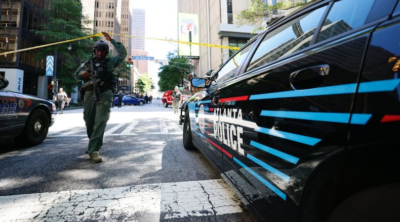 Police work the scene where four people, including a suspect, were injured Tuesday, June 11, 2024, during a shooting in a busy downtown Atlanta food court. (Miguel Martinez/AJC)